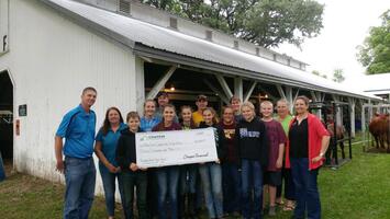 Group picture of teenagers with a donation check from Compeer Financial